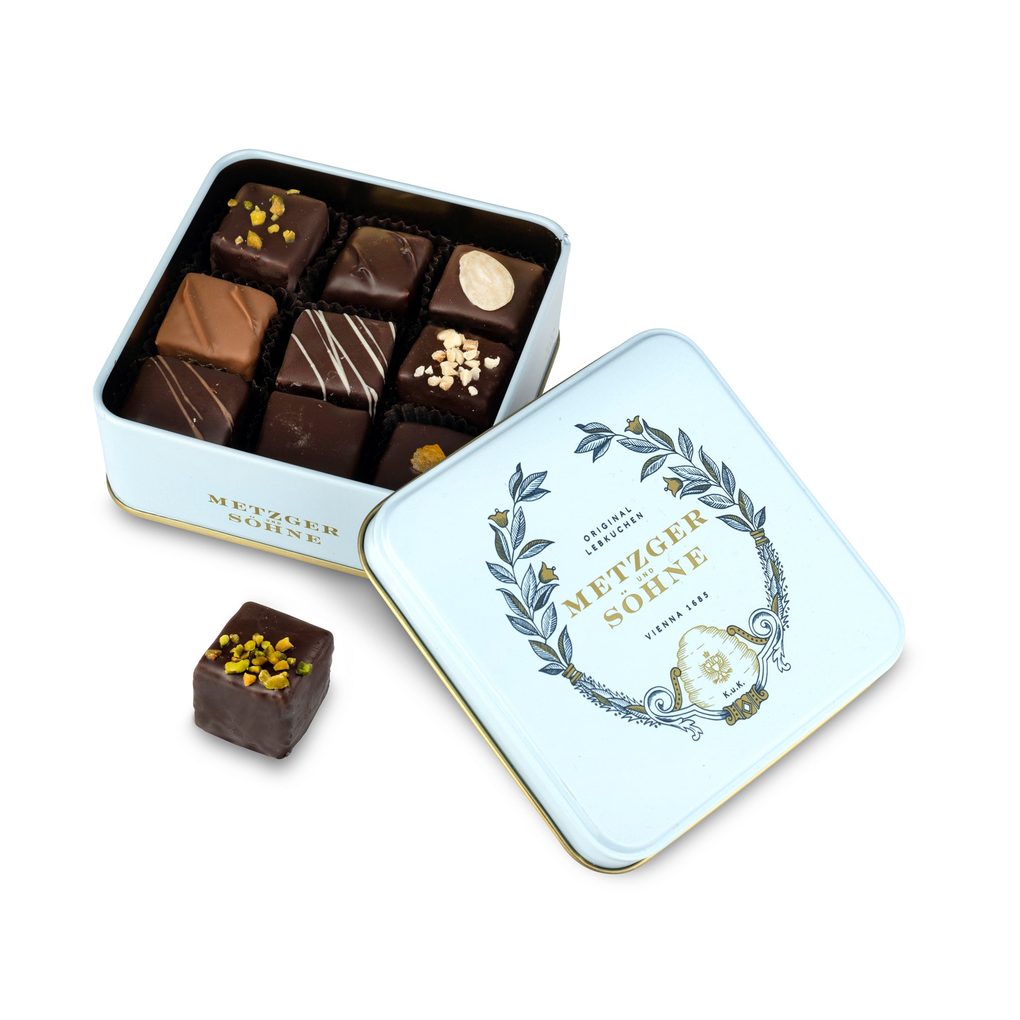 A perfect gift for a special occasion. Metzger's signature luxury tin in ice blue, filled with with 9 delectable Lebkuchen chocolate pralines. Each praline is layered with Lebkuchen 'honey cake' and filled with marzipan, nuts or fruit jams and jellies, encased in rich chocolate. Suitable for vegetarians.