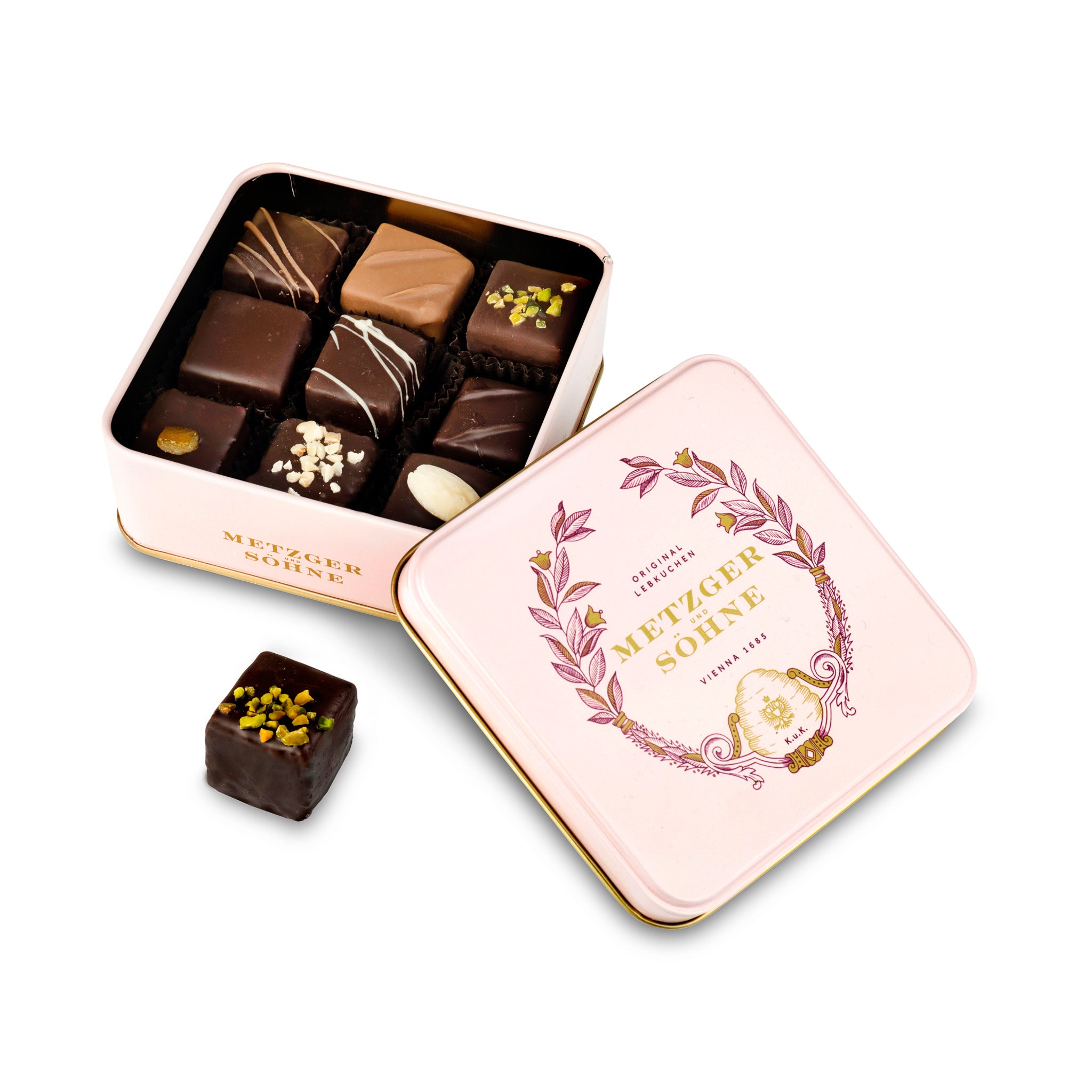 A perfect gift for a special occasion. Metzger's signature luxury tin in delicate pink, filled with with 9 delectable Lebkuchen chocolate pralines. Each praline is layered with Lebkuchen 'honey cake' and filled with marzipan, nuts or fruit jams and jellies, encased in rich chocolate. Suitable for vegetarians.