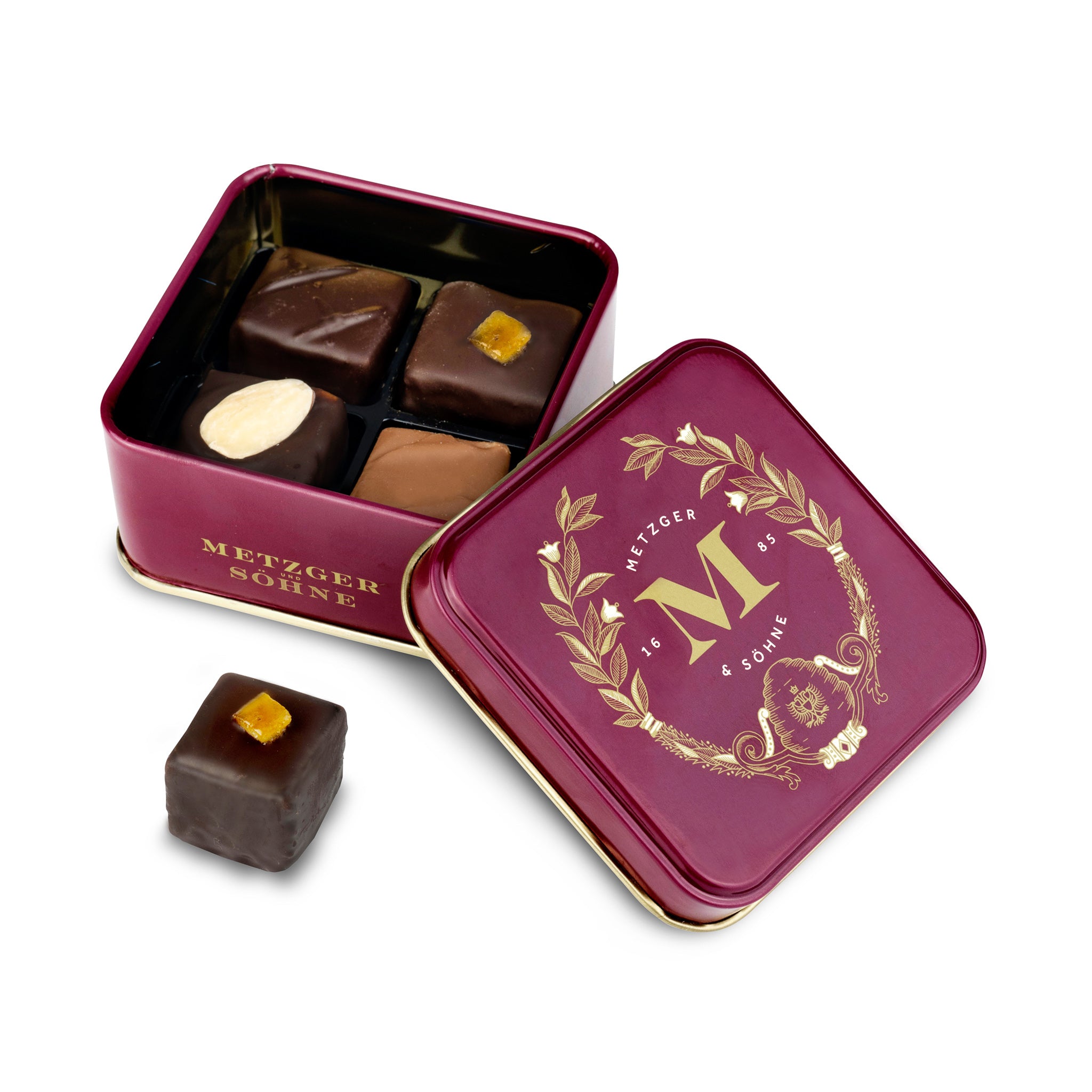 Petit Metzger signature tin in red filled with 4 different Lebkuchen 'honey cake' pralines.