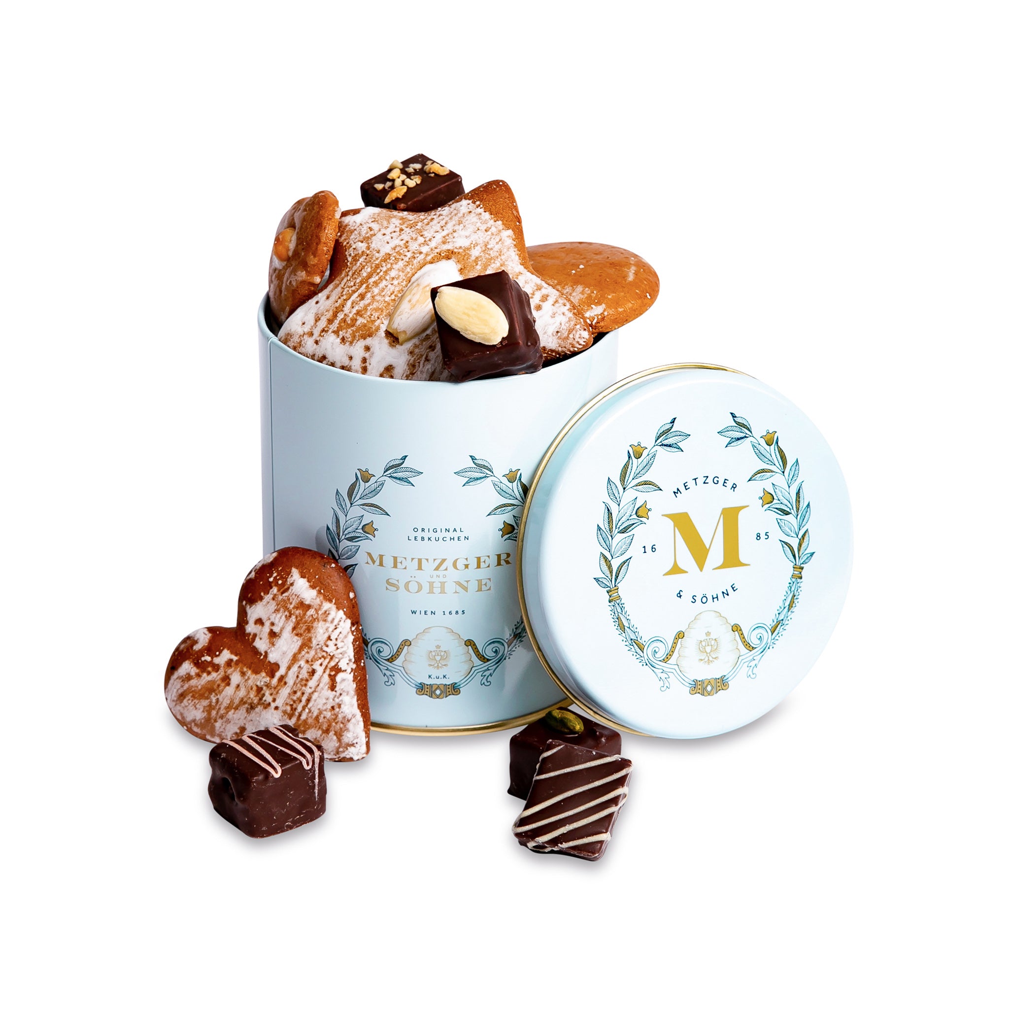 Luxury Metzger gift tin in blue, filled with our popular Lebkuchen cookies and chocolate pralines. There are 10 opulent praline types, from marzipan mixes to fruit jellies, jams and nut fillings, coated in chocolate. The Lebkuchen cookies include our fruit bread with dried fruits and nuts, basler with a cherry undertone, chocolate robbins, signature house Lebkuchen and Aranzini Lebkuchen minis. A perfect Lebkuchen taster gift or selection for the Christmas table.