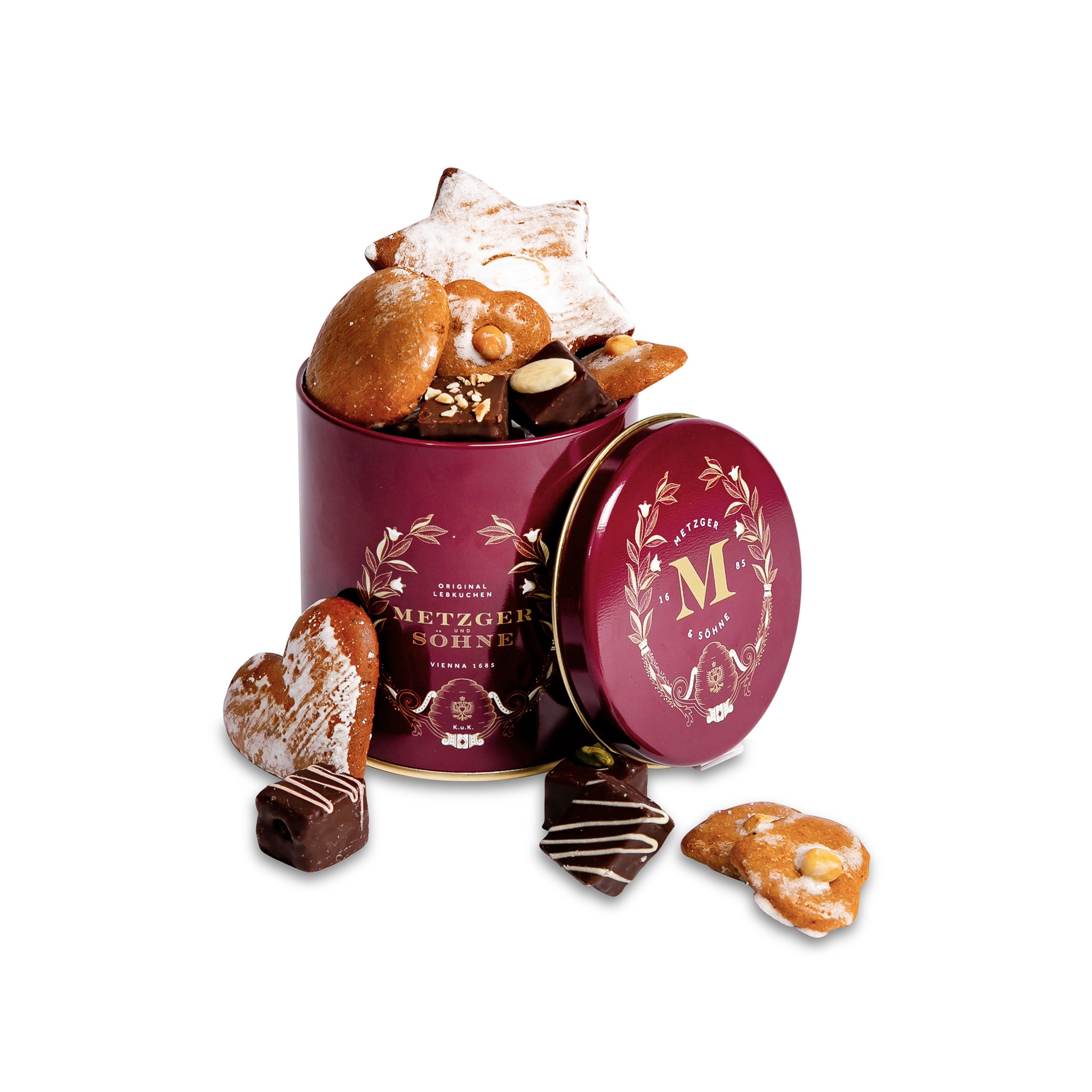Luxury Metzger gift tin in red, filled with our popular Lebkuchen cookies and chocolate pralines. There are 10 opulent praline types, from marzipan mixes to fruit jellies, jams and nut fillings, coated in chocolate. The Lebkuchen cookies include our fruit bread with dried fruits and nuts, basler with a cherry undertone, chocolate robbins, signature house Lebkuchen and Aranzini Lebkuchen minis. A perfect Lebkuchen taster gift or selection for the Christmas table.