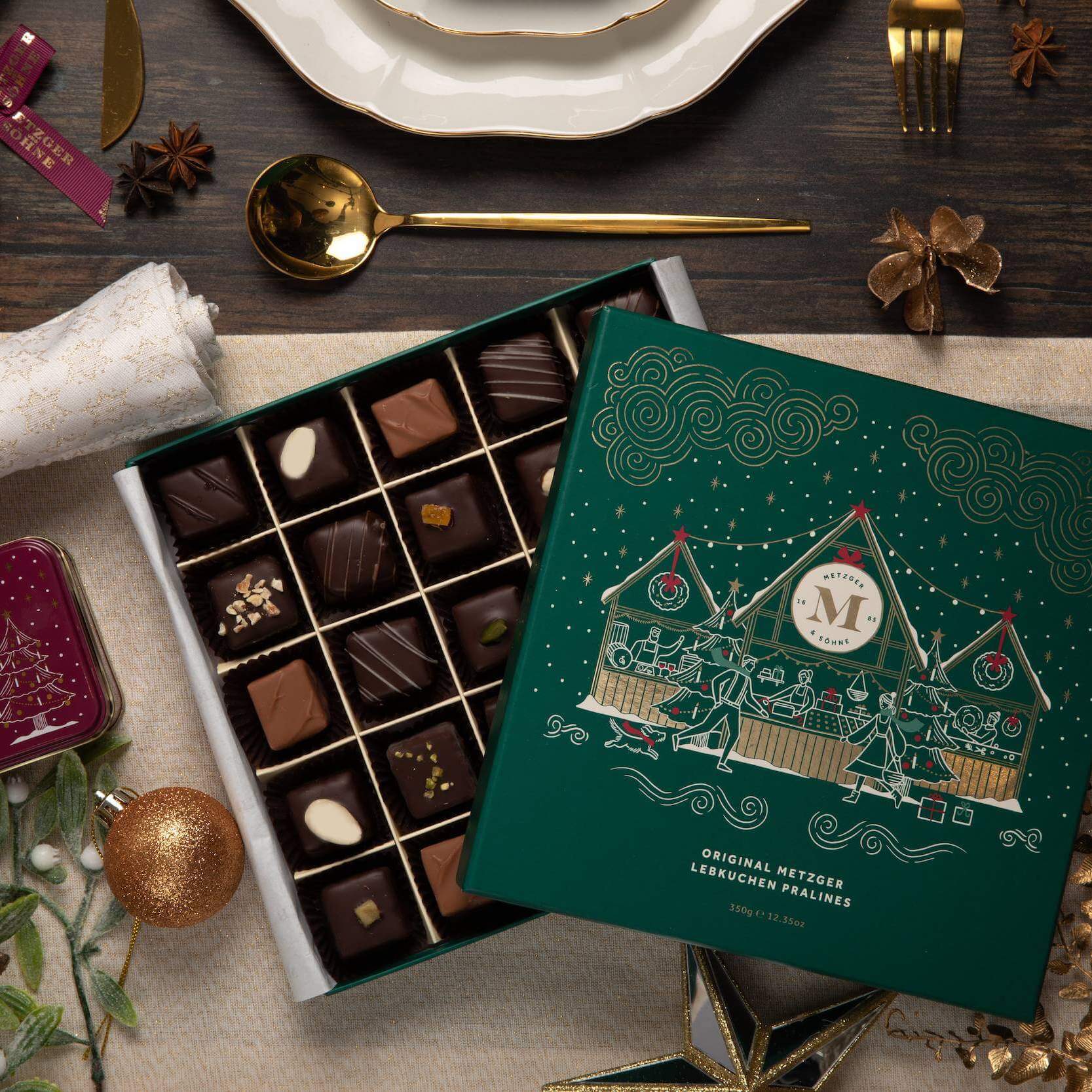 Metzger is pleased to bring you the magic of Viennese Christmas markets with a luxury chocolate box in emerald green, filled with 25 delectable Lebkuchen pralines. Each praline is layered with Lebkuchen 'honey cake' and filled with marzipan, nuts or fruit jams and jellies, encased in rich chocolate.
