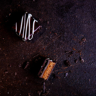 6 handcrafted Lebkuchen 'honey cake' pralines filled with opulent currant jelly and marzipan, enrobed in dark chocolate and topped with white chocolate. The high quality chocolate couvertures enchant with an indulgent flavour, perfectly complimenting our Lebkuchen.