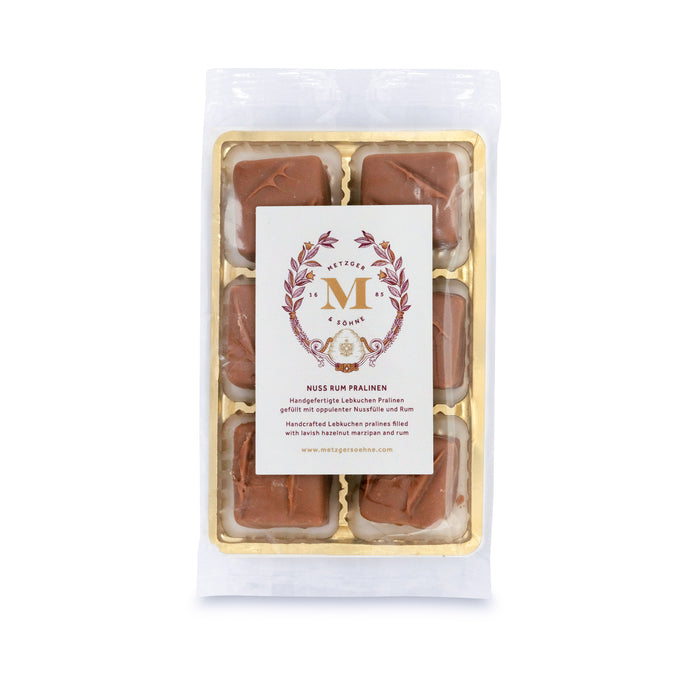 6 handcrafted Lebkuchen 'honey cake' pralines filled with opulent hazelnut marzipan and rum, coated in delicate milk chocolate. A delicious taste of Christmas in every bite.