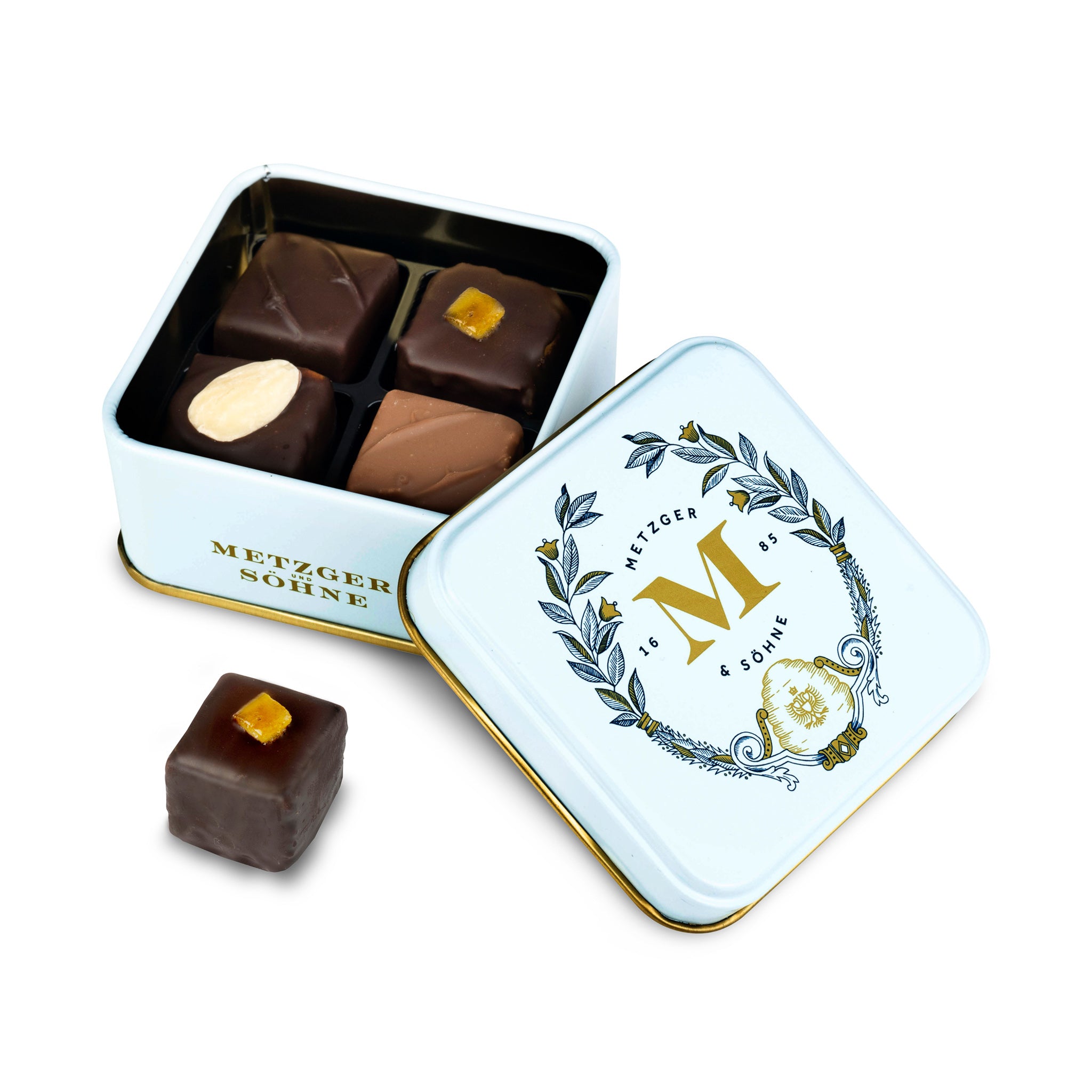 Petit Metzger signature tin in pastel blue filled with 4 different Lebkuchen 'honey cake' pralines: almond, orange marzipan, nut rum and aranzini.