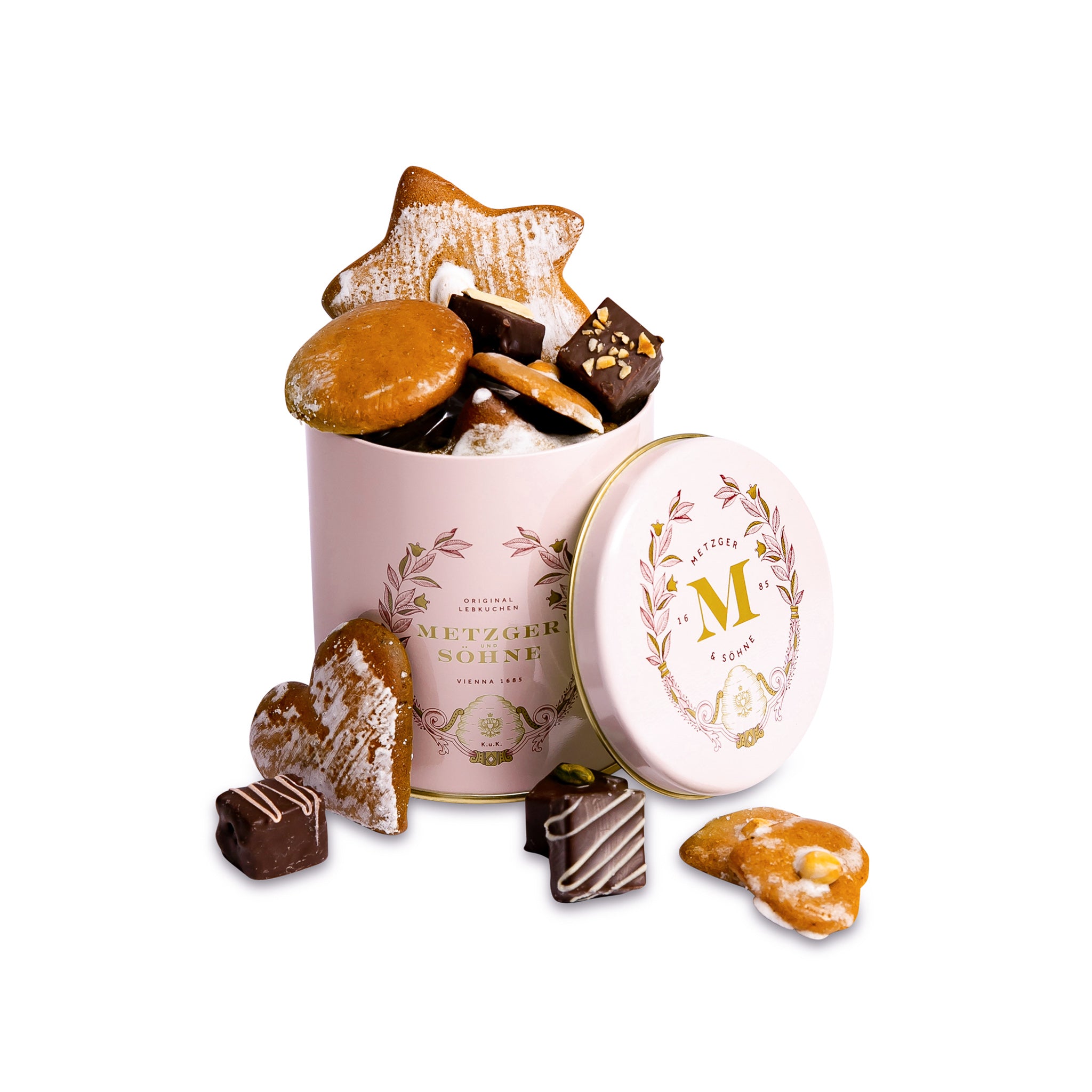 Luxury Metzger gift tin in pink, filled with our popular Lebkuchen cookies and chocolate pralines. There are 10 opulent praline types, from marzipan mixes to fruit jellies, jams and nut fillings, coated in chocolate. The Lebkuchen cookies include our fruit bread with dried fruits and nuts, basler with a cherry undertone, chocolate robbins, signature house Lebkuchen and Aranzini Lebkuchen minis. A perfect Lebkuchen taster gift or selection for the Christmas table.
